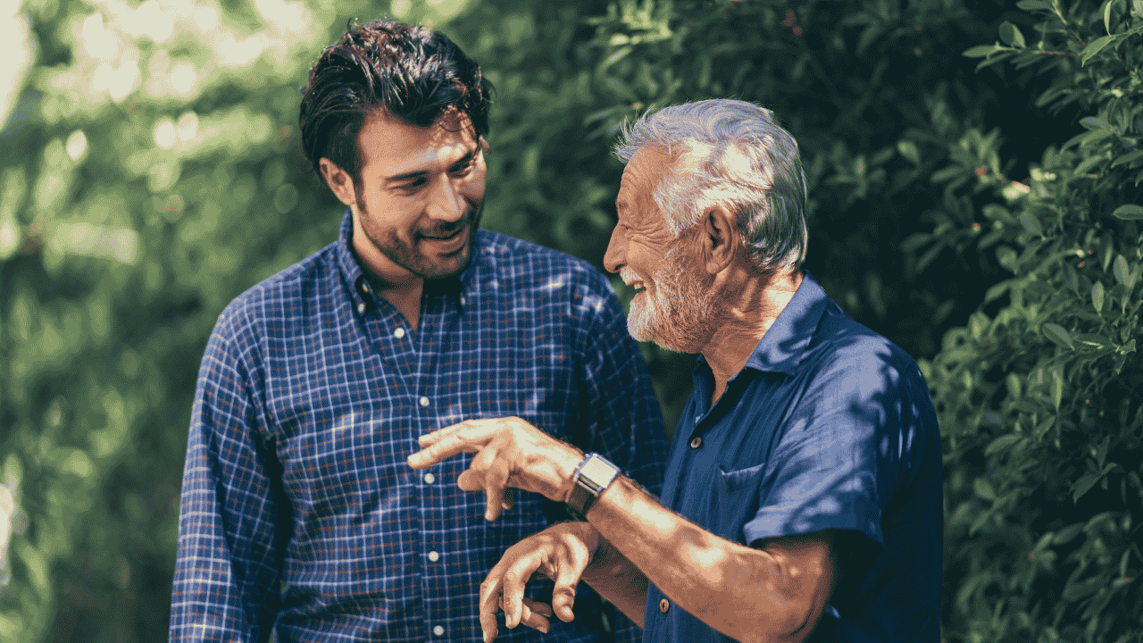Caring adult son talking with his elderly parent, aligned with can you get paid to care for elderly parent.